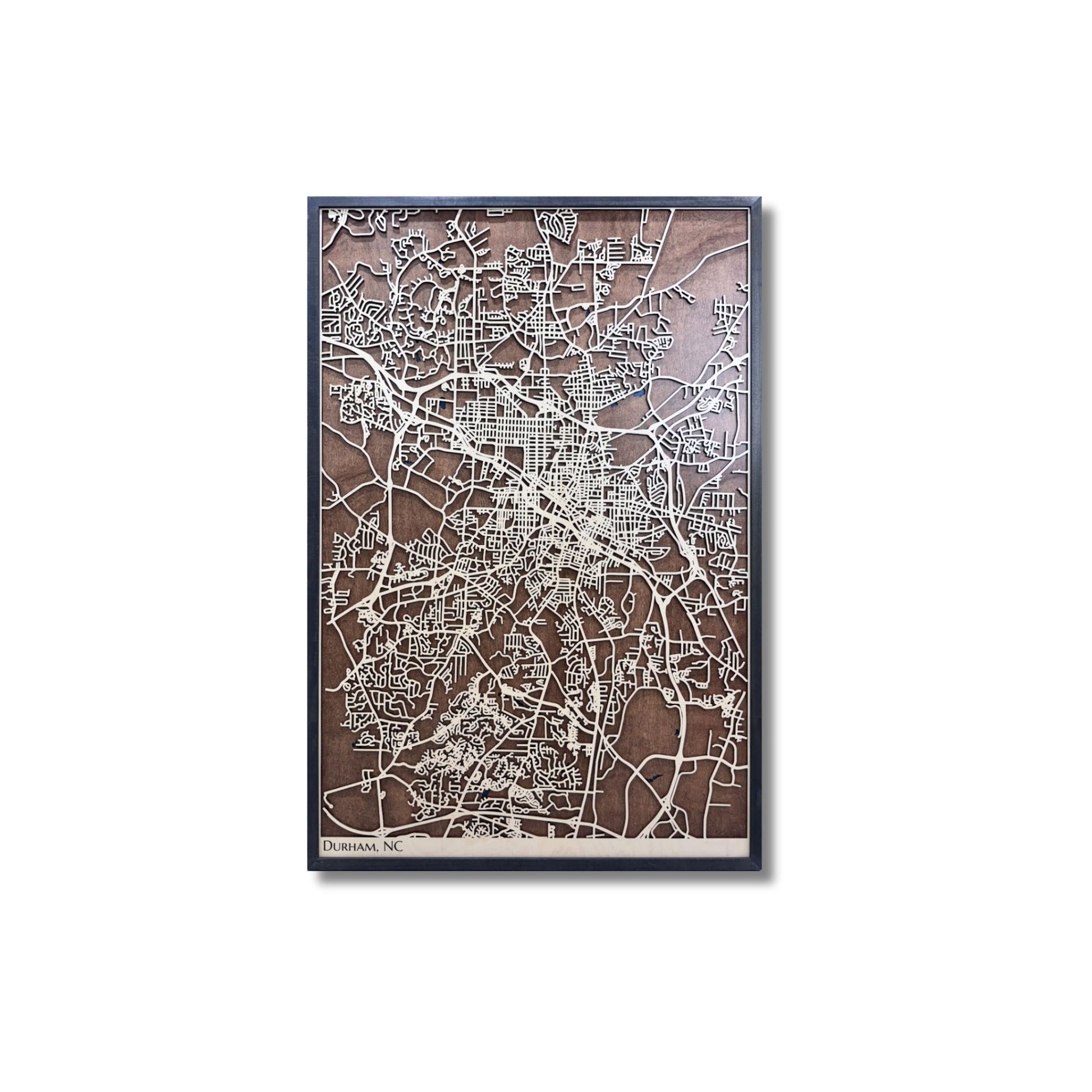 3D wooden city map of Durham, NC on a white background. 
