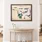 Framed golf map of Eagles Landing Golf Club on a wall above a wooden table.