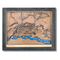 3D wooden map of Fairbanks, Alaska with raised and engraved roads, blue water stain, and a black frame. 