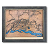 3D wooden map of Fairbanks, Alaska with raised and engraved roads, blue water stain, and a black frame. 