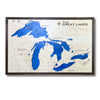 Large wooden multilayer map of The Great Lakes on a white background. 