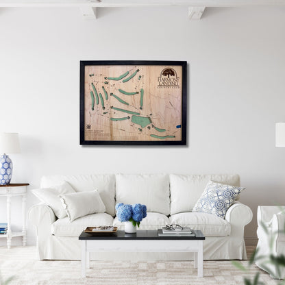 Harmony Landing golf map hanging on a wall above a couch. 