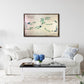 Living room with a white sofa, coffee table, and framed wooden golf map on the wall.