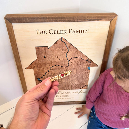 Custom wood house-shaped map with six removable icons. 