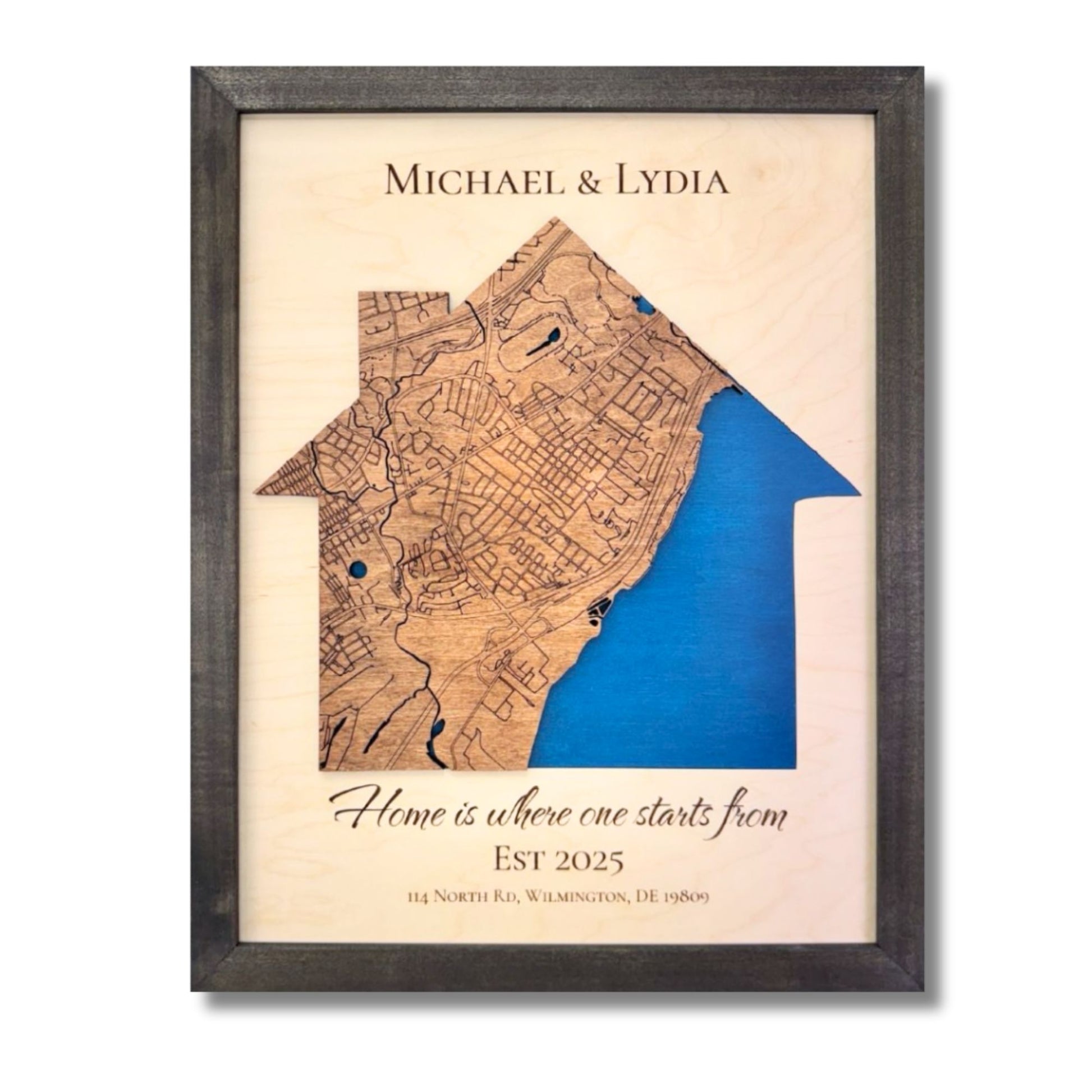 Custom house-shaped map with blue water stain, personalized text, and a black frame. 