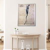 Wooden Lake Champlain map with natural color frame hanging on a wall above a table. 