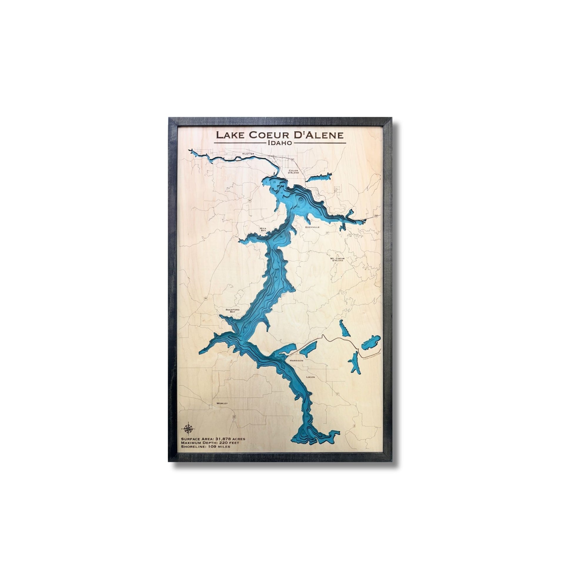 Framed map of Lake Coeur D'Alene with blue water and beige landmasses on a white background.