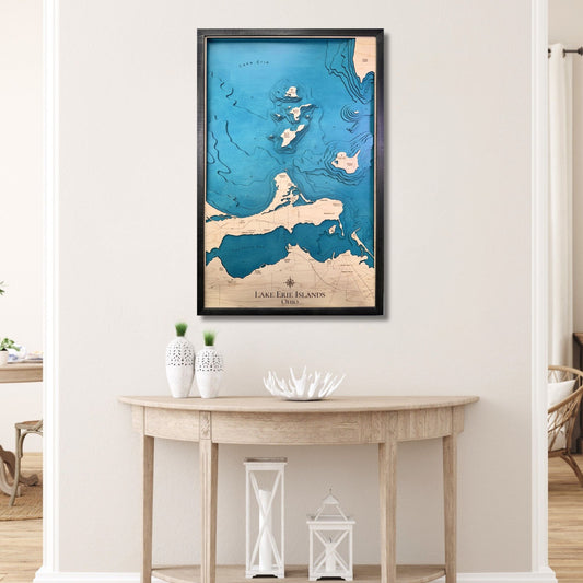 Large Lake Erie Islands wooden map with black frame hanging on a wall over a table. 