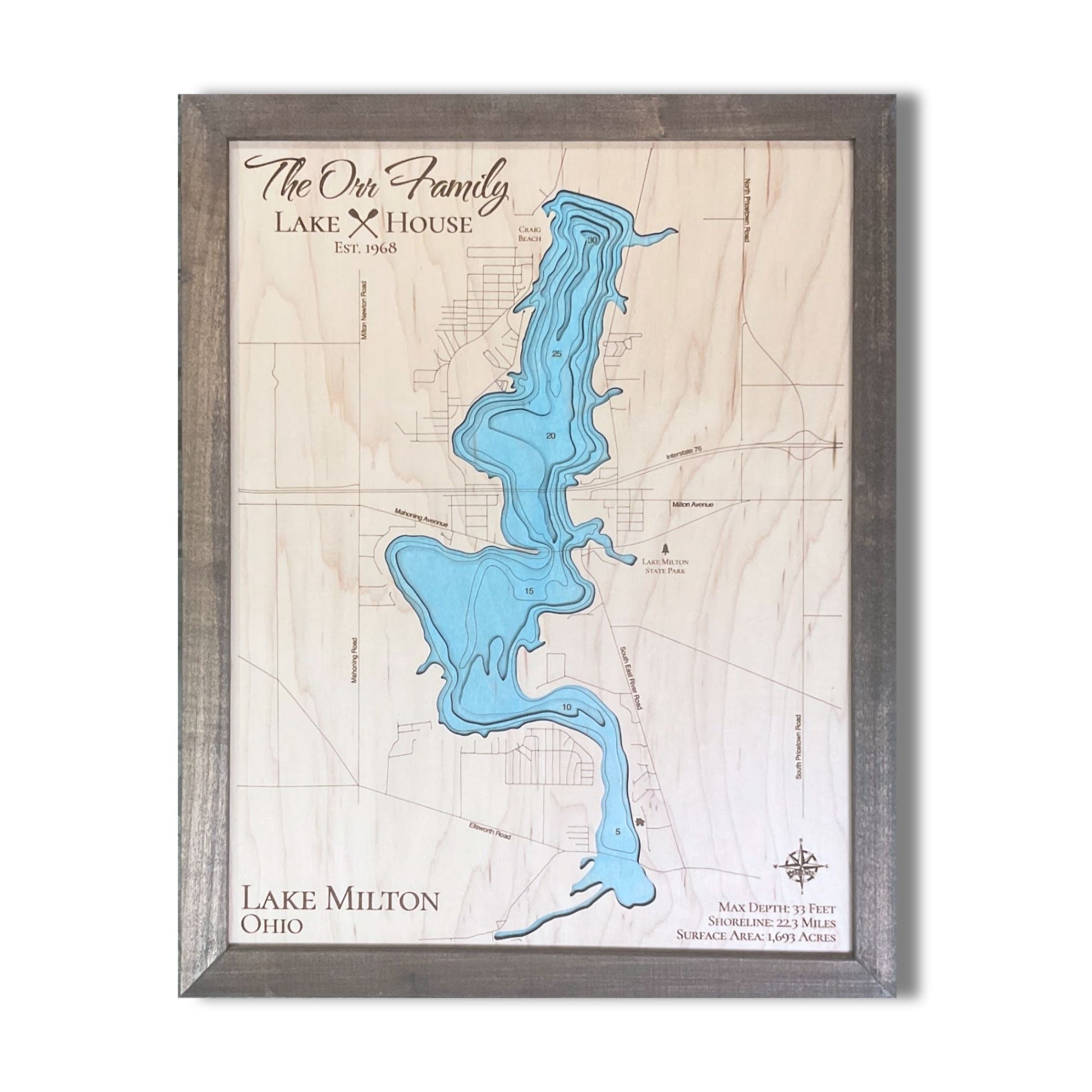 Wooden map of Lake Milton, Ohio with a light blue water stain.