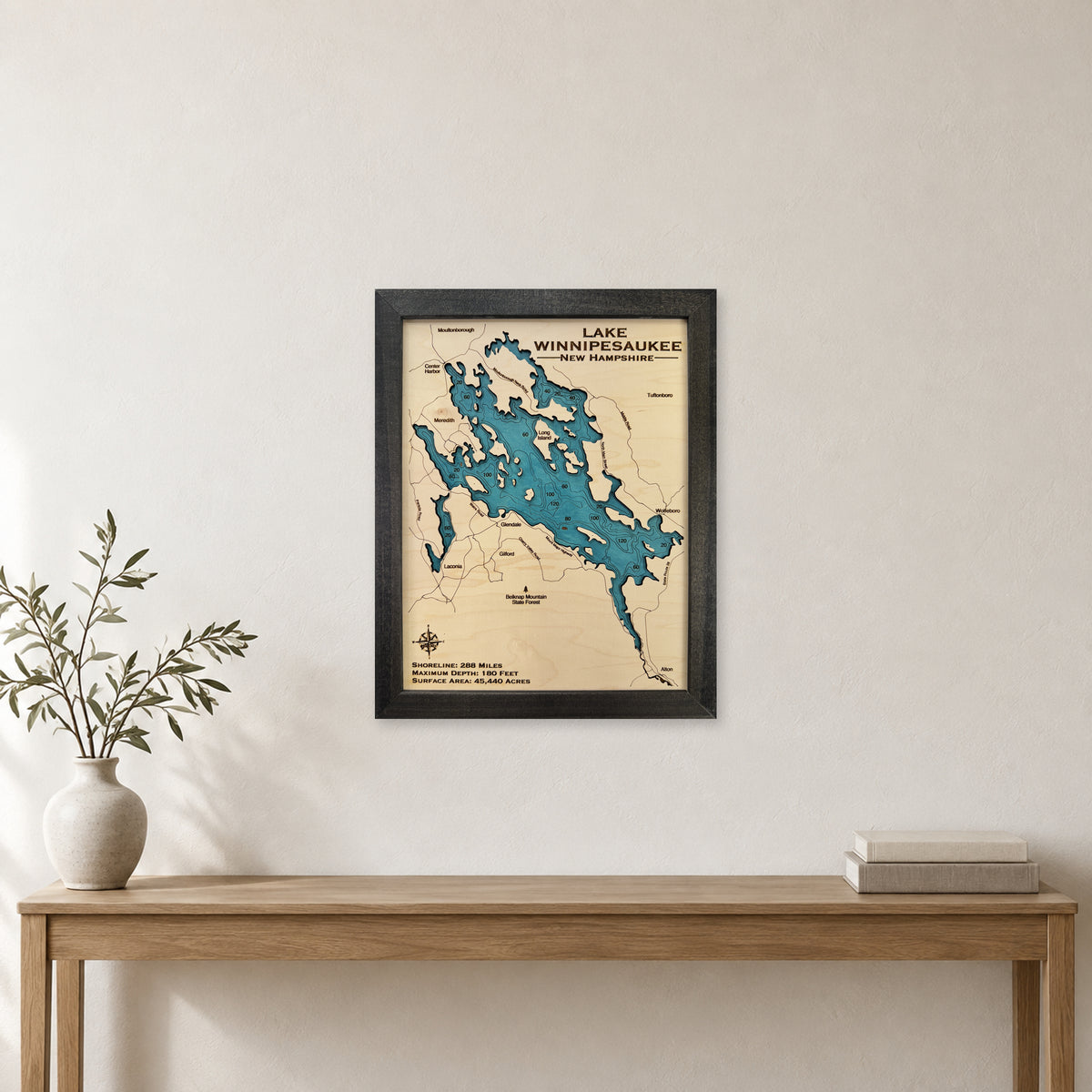 Lake Winnipesaukee wood map — single layer with engraved contours, staged room mockup