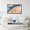 A large framed wooden map of Straits Golf Course hanging on a living room wall above a couch. 