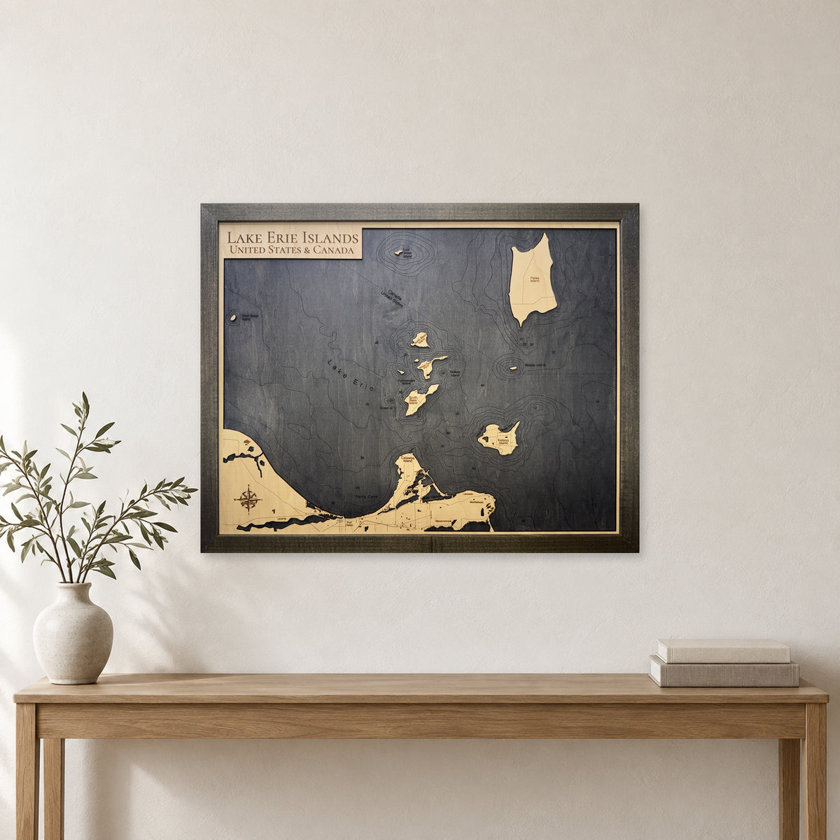 Lake Erie Islands Engraved Contours Charcoal Frame Wood Map — room mockup [MC20261006 legacy 6484587893c7]