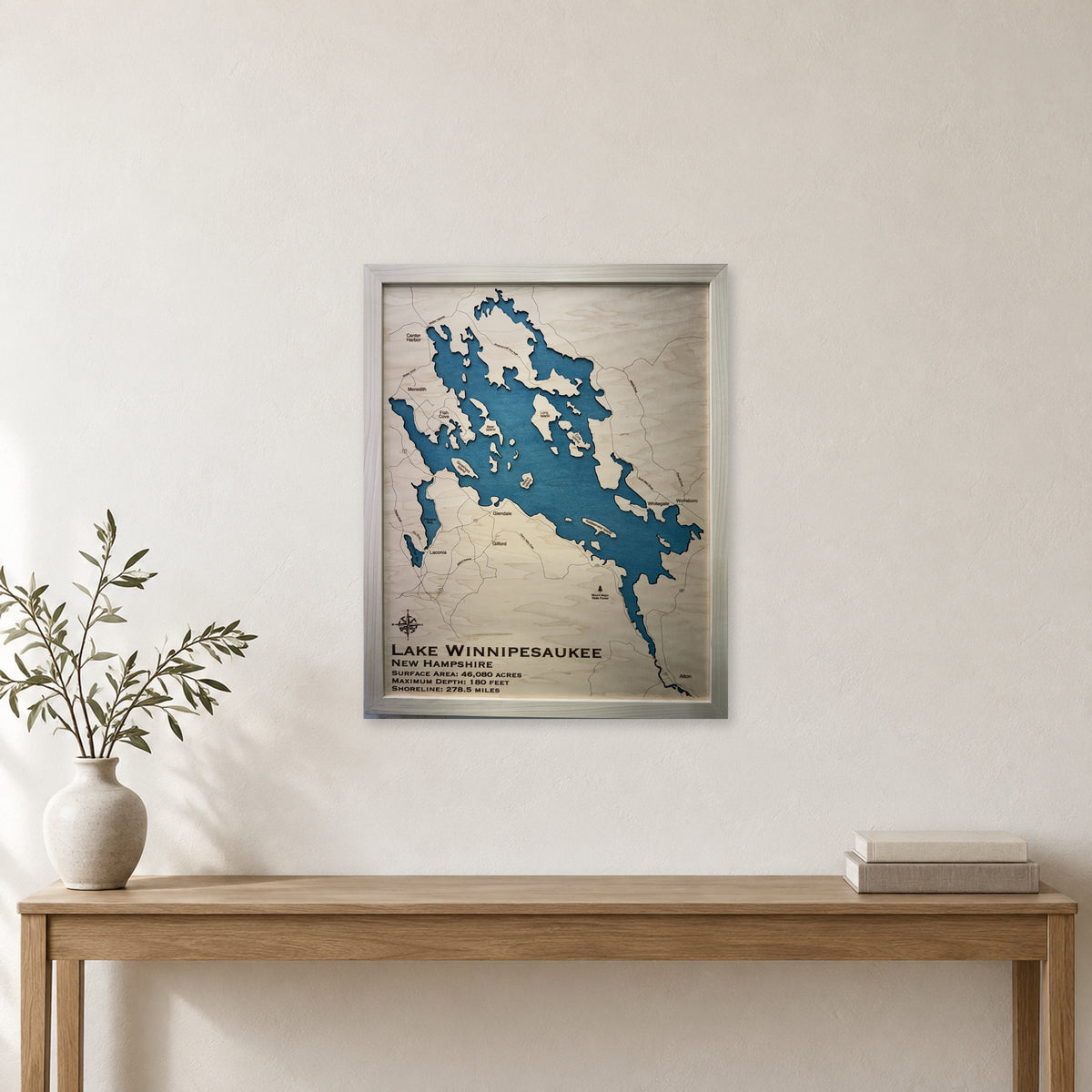 Lake Winnipesaukee New Hampshire Single Water White Frame Wood Map — room mockup [MC20261006 legacy ce20eea59205]