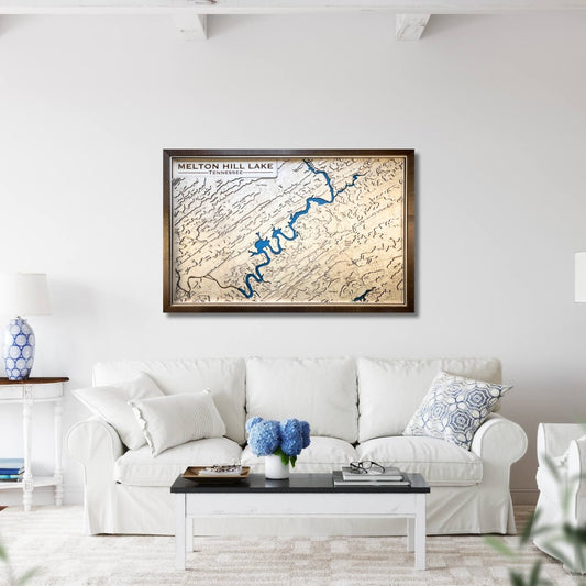 Living room with a framed topographic map of Melton Hill Lake on the wall above a white sofa.