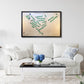 Framed golf course map on a wall above a white sofa with decorative pillows.
