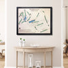 Framed 3D wooden map of Mooresville Golf Club on a wall above a wooden table.