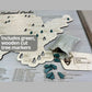Close up of the national parks travel map and the green tree markers that come with it to track your travels. 