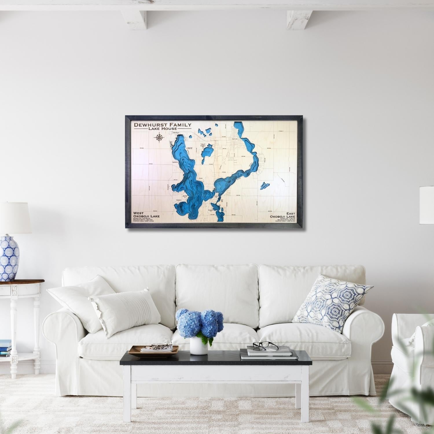Large Okoboji Lakes wooden map hanging on wall above a couch. 