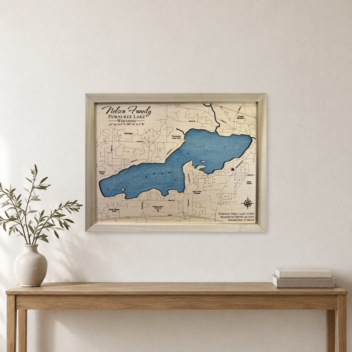 Pewaukee Lake wood map — single layer with engraved contours, staged room mockup