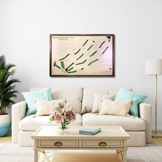 Living room with a beige sofa, coffee table, and framed wooden golf map on the wall.