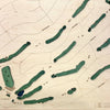 Close up of wooden golf course map with green fairways, blue water hazards, and engraved text. 