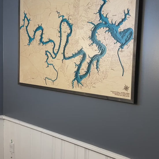 Lake Travis wooden map: a close-up of the blue layers, engraved shoreline and walnut-colored frame.