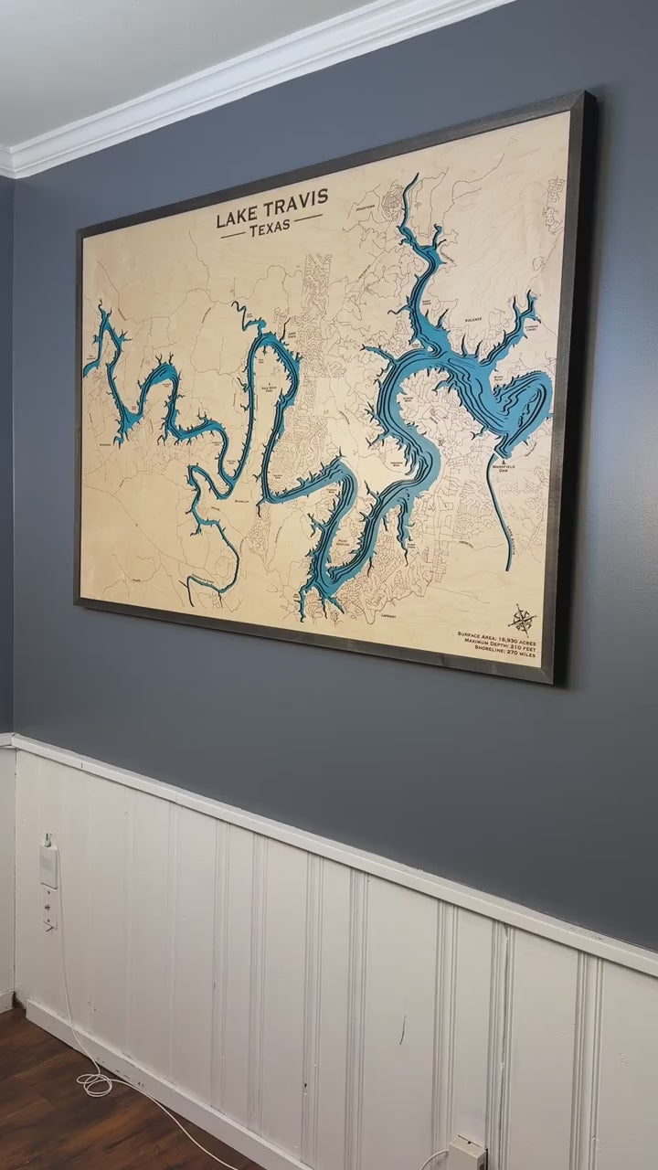 Lake Travis wooden map: a close-up of the blue layers, engraved shoreline and walnut-colored frame.