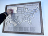 Wooden US travel map with removable pieces. Image shows some state pieces in place. 
