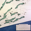 Close up of wooden golf course map with green fairways, blue water hazards, and engraved text. 