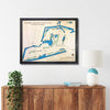 Framed map of Sanibel Island Golf Club on a wall above a wooden console table.