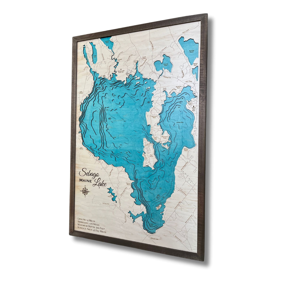 Sideview of the cut water layers on a large Sebago Lake wood map. 