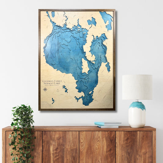 Custom Sebago Lake map hanging on the wall above a console. 