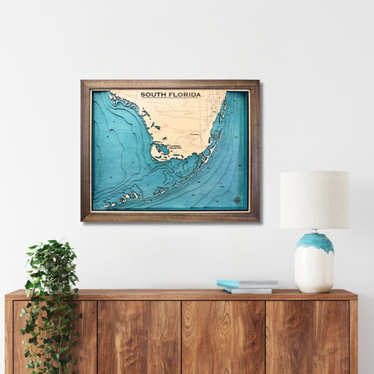 Framed South Florida and Florida Keys map hanging on a wall above a console. 