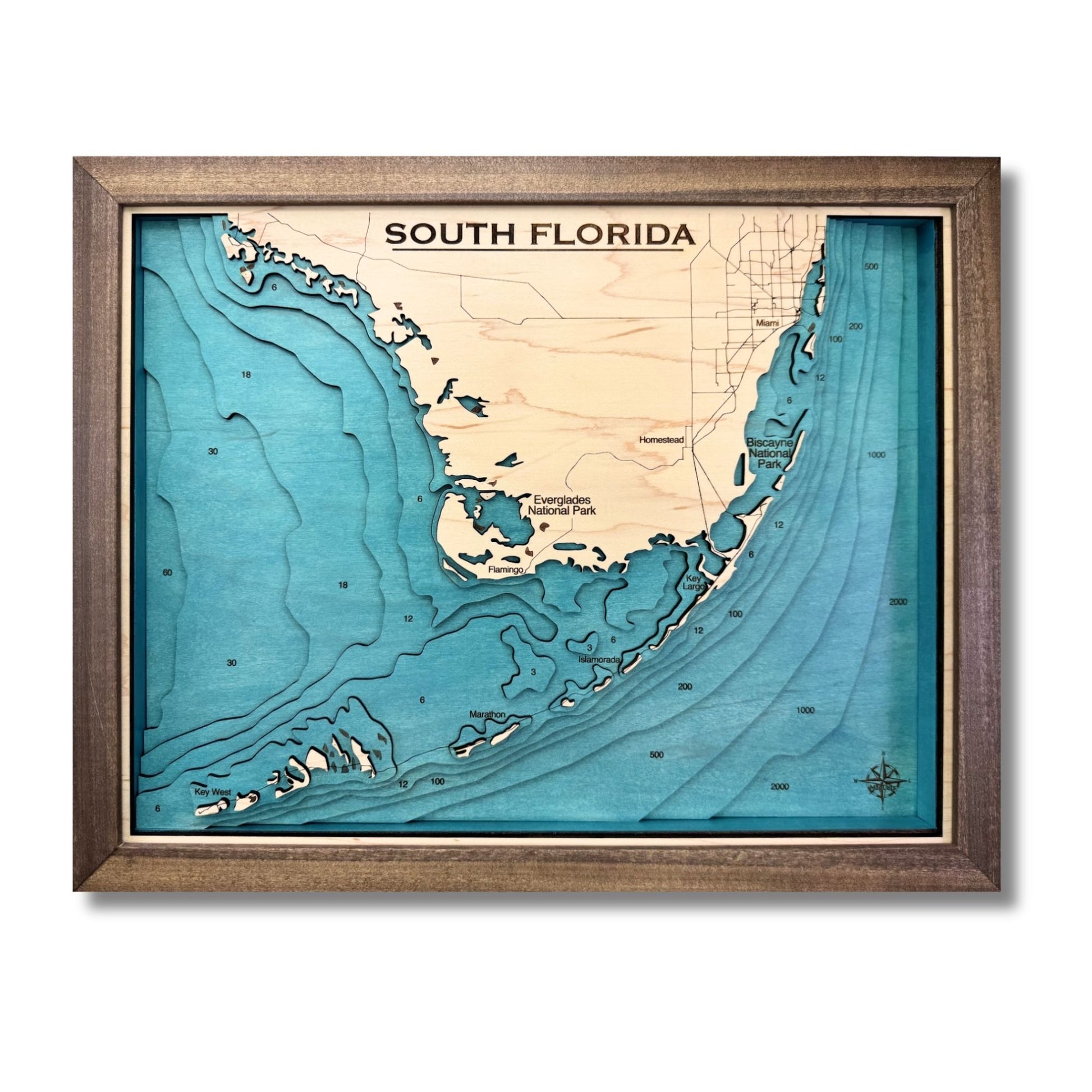 Wooden map of South Florida and the Keys with engraved text and multi water layers. 
