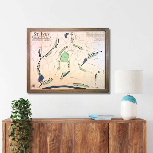 Framed wooden golf map of St. Ives Country Club on a wall above a wooden console table.