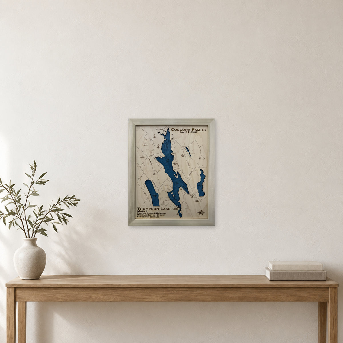 Thompson Collura wood map — single layer with engraved contours, staged room mockup