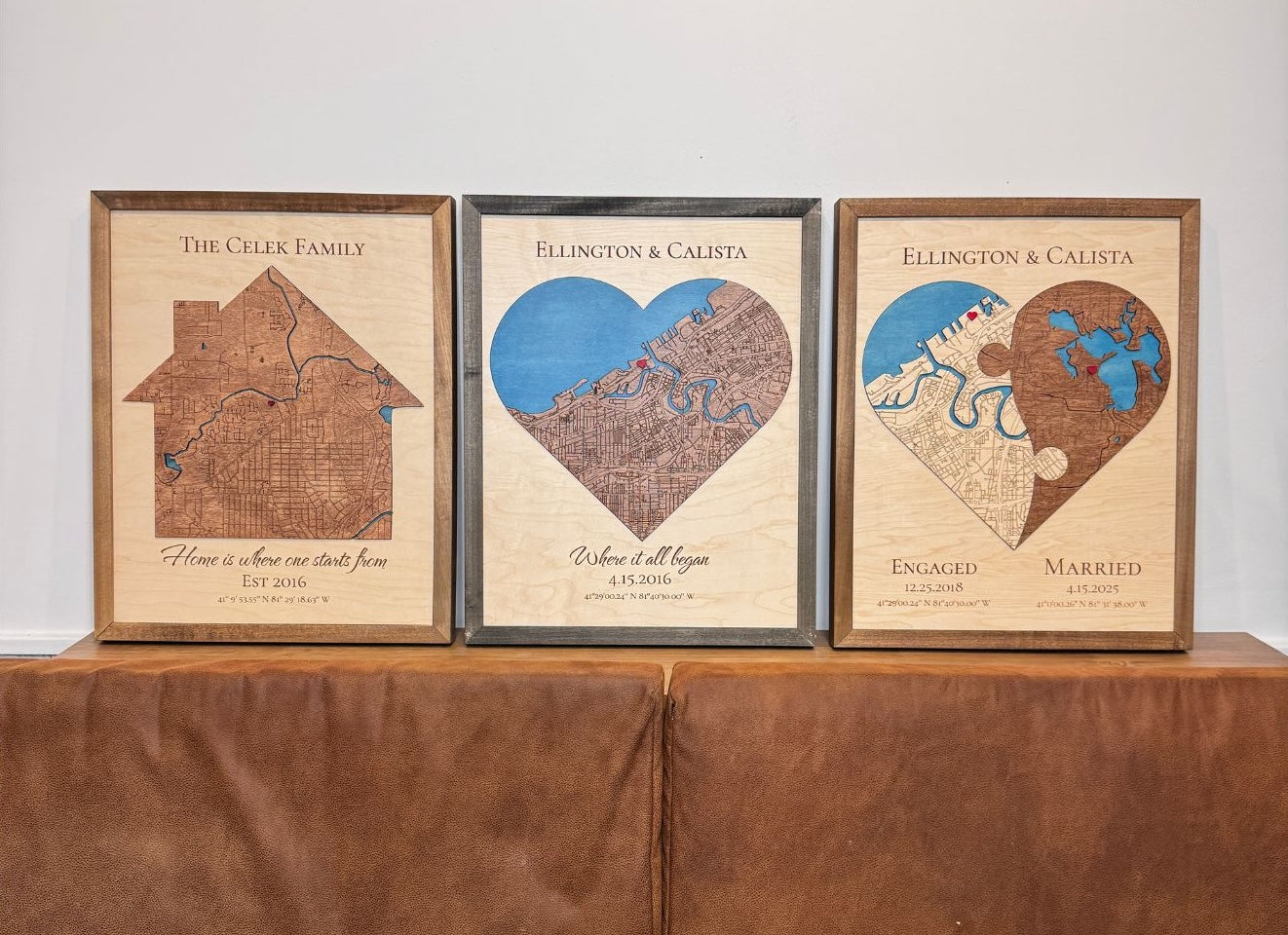 Three maps sit in a row on a table: a house-shaped map and two variations of the heart-shaped maps. All maps have attached icons. 