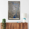 Framed city map of Tokyo on a wall above a wooden cabinet with decorative items.