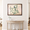 Framed wooden golf map of Tripoli Country Club on a wall above a wooden table.