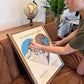 Woman placing a red removable icon on a heart-shaped wedding gift map. 