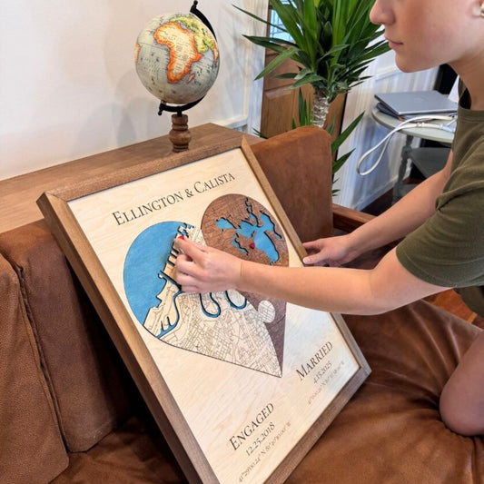 Woman placing a red removable icon on a heart-shaped wedding gift map. 