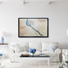 Framed wooden map of a lLake Havasu on a wall above a white sofa in a living room.