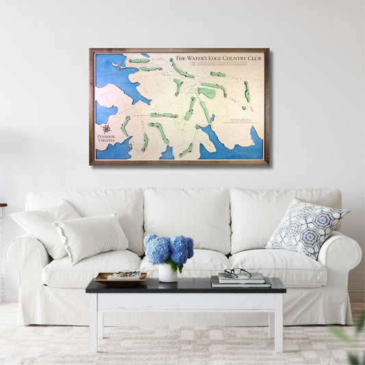 Living room with a white sofa, coffee table, and The Water's Edge golf course map on the wall.
