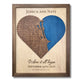 Custom wooden heart-shaped map with engraved roads, blue water stain, personalized text, and a walnut brown frame. 