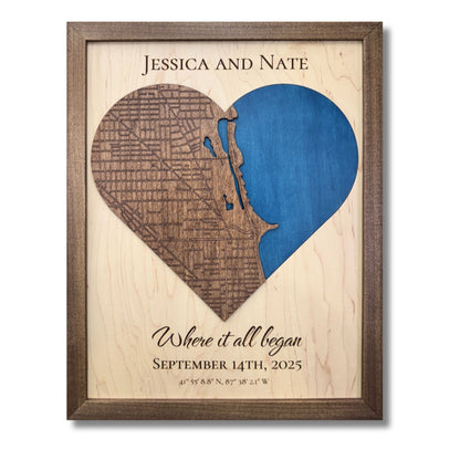 Custom wooden heart-shaped map with engraved roads, blue water stain, personalized text, and a walnut brown frame. 