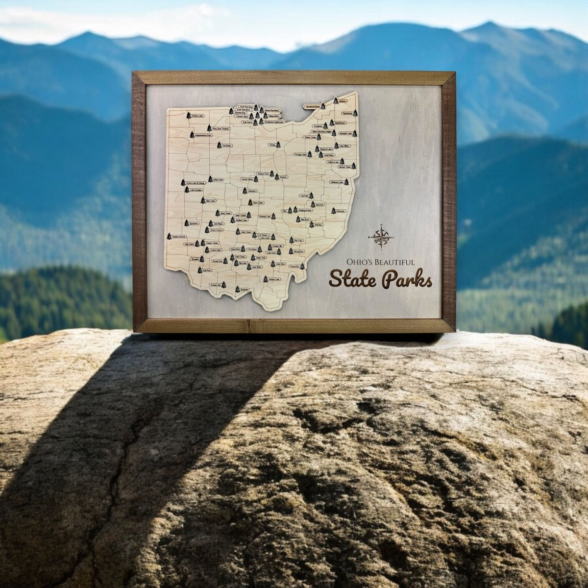 The Ohio state park travel map sitting on a rock outdoors. 
