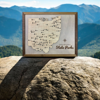 The Ohio state park travel map sitting on a rock outdoors. 