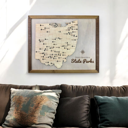 Wooden Ohio state park travel map hanging on wall above couch. 