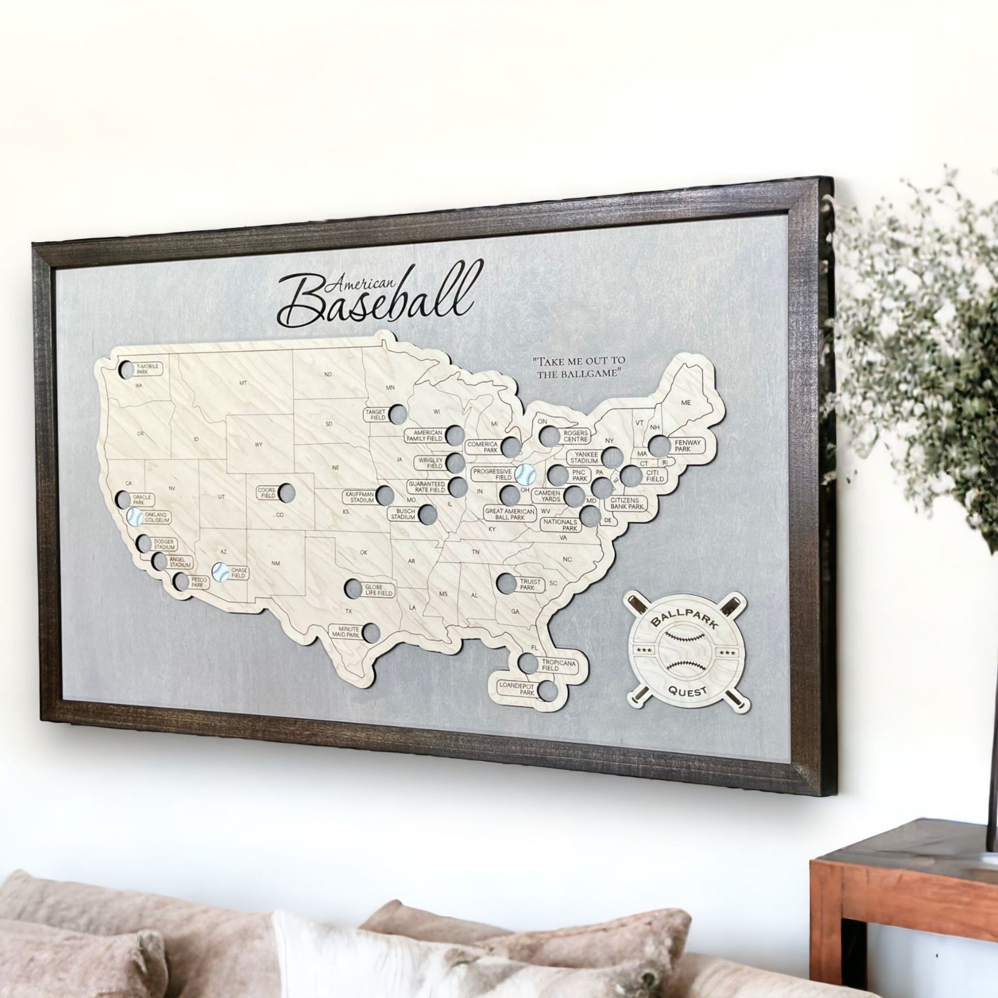 Professional Baseball Travel Map hanging on a wall above a sofa. 