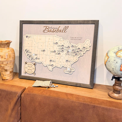 Framed Professional Baseball Travel Map with a bag of baseball markers sitting on a narrow ledge against a wall. 